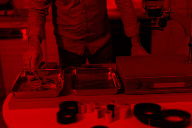 istock Photographer making photos in a darkroom 2199040273