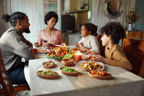 istock Happy black family talking during lunch in dining room. 2199040414