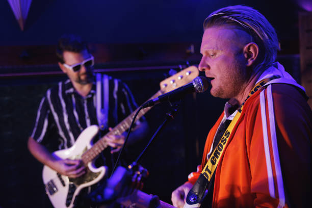 istock Two middle aged men playing music together 2199041786
