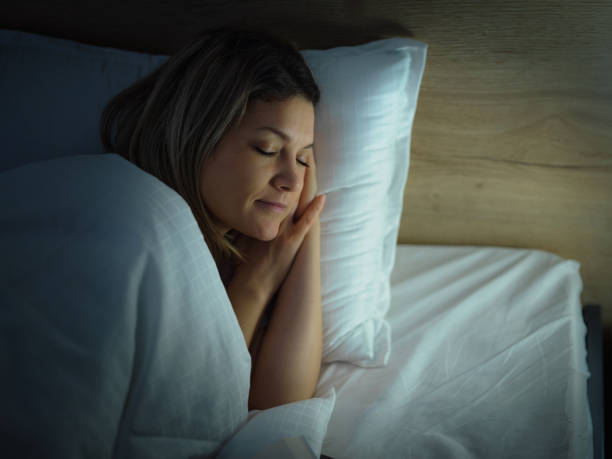 istock Relaxed woman sleeping in bed at night. 2199041821