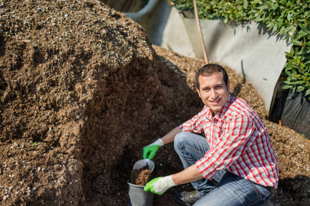 istock farmer moving a pile of manure 2199042075