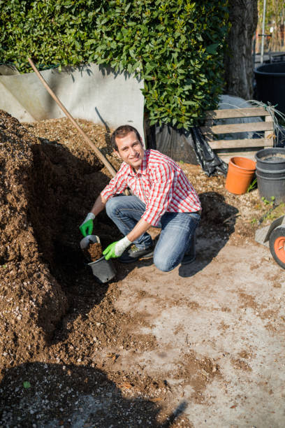 istock farmer moving a pile of manure 2199042110