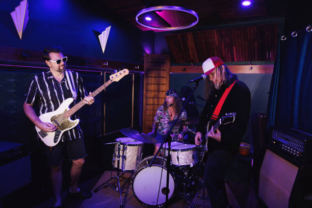 Middle aged men getting the band together for a jam session