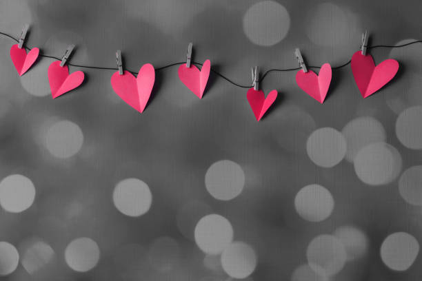 istock Paper hearts on a clothesline with bokeh lights and space for copy 2199042292