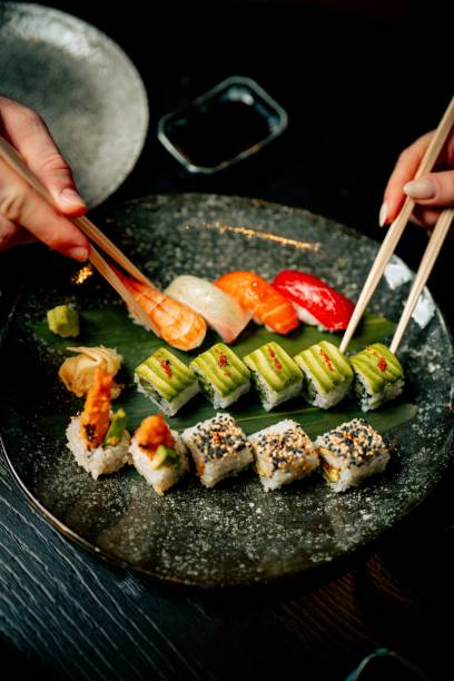 istock Close-up of diverse sushi selection with chopsticks. 2199042572