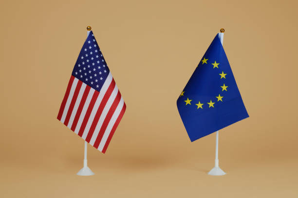 The US flag on the background of the flag of the European Union.