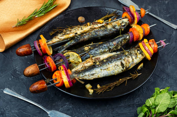 istock Fish and vegetable skewer in barbecue grill. 2199051751