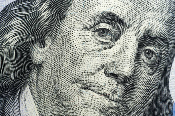 istock Extreme close-up of Benjamin Franklin's portrait on a US hundred-dollar bill 2199052191