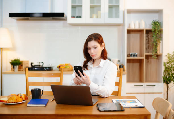 istock Two professionals collaborating on a business project over coffee in a cozy kitchen. 2199056974