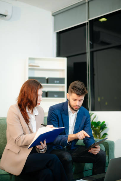 istock Two professionals in a business meeting, discussing strategy and collaboration in a modern office setting. A perfect concept 2199057011