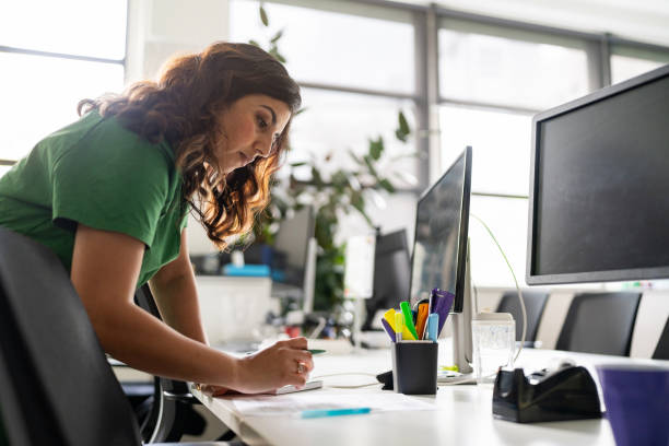 Professional Woman Working at a Modern Office Desk During Daytime