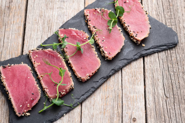 istock Sliced tuna steak with sesame photography . Top view 2199061098