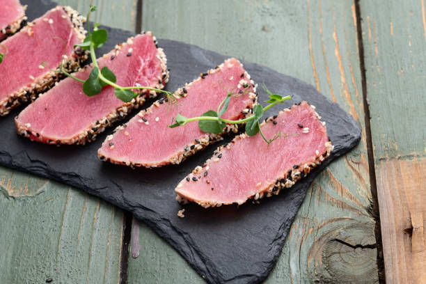 istock Sliced tuna steak with sesame photography . Top view 2199061101