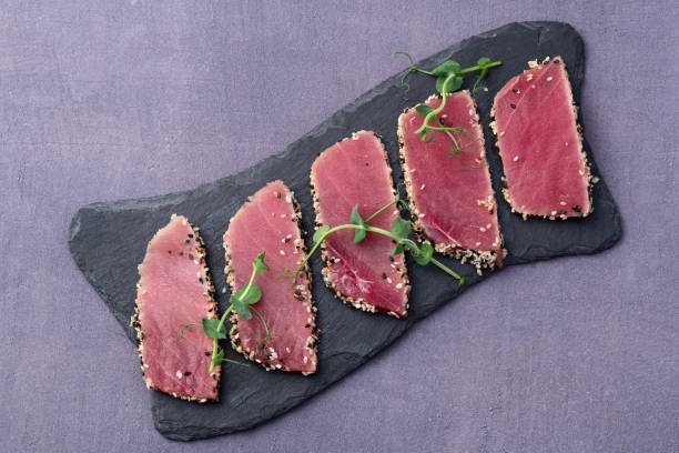 istock Sliced tuna steak with sesame photography . Top view 2199061111