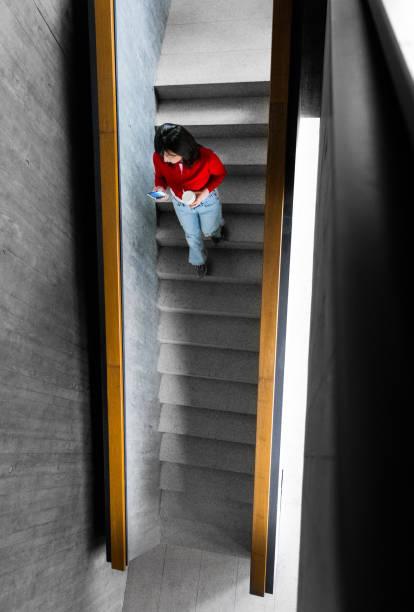 Unlock potential of learning and education concept with ladder of success, books and magnifying glass on red background. Large free copy space.