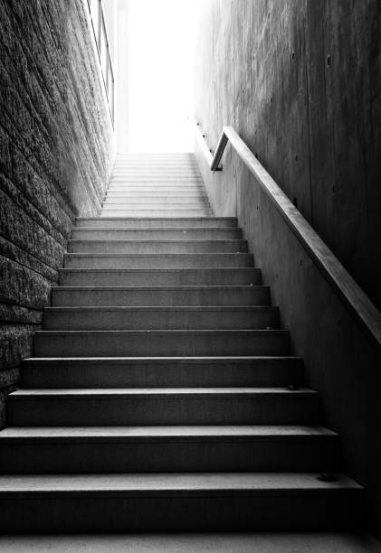 istock Low angle view of long stairs going up with bright sunlight 2199062159