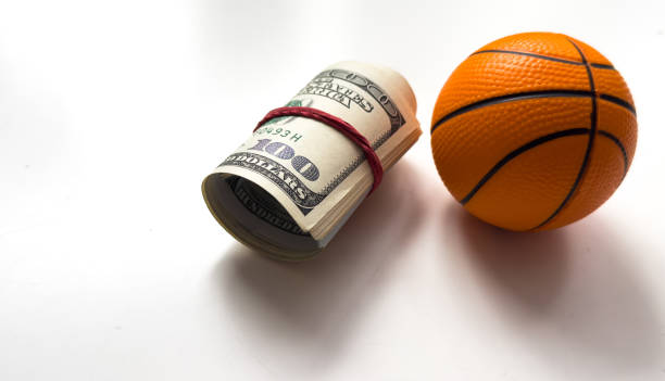 istock Small basketball ball dollars isolated on a white background 2199063239