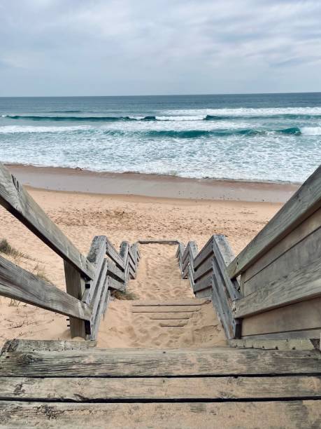 istock Wooden Staircase Leading to Serene Beach 2199063426