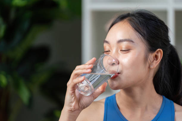 istock Active woman enjoying a refreshing drink, promoting hydration and wellness in a modern setting. 2199063511