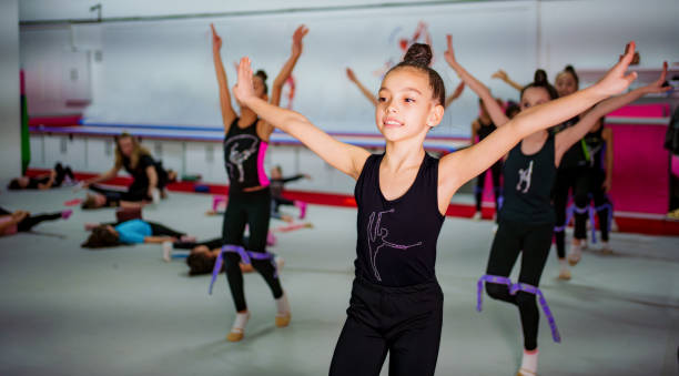 istock Young Gymnasts Practicing Ballet Poses in a Gymnastics Training Center 2199064111