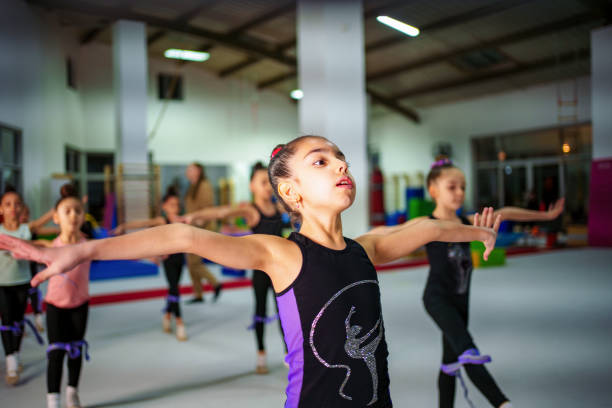 istock Young Gymnasts Practicing Ballet Poses in a Gymnastics Training Center 2199065080
