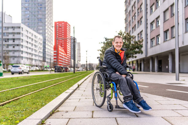istock Young man with a disability in a wheelchair 2199066649