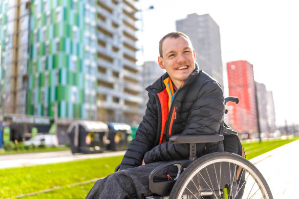 istock Young man with a disability in a wheelchair 2199066823