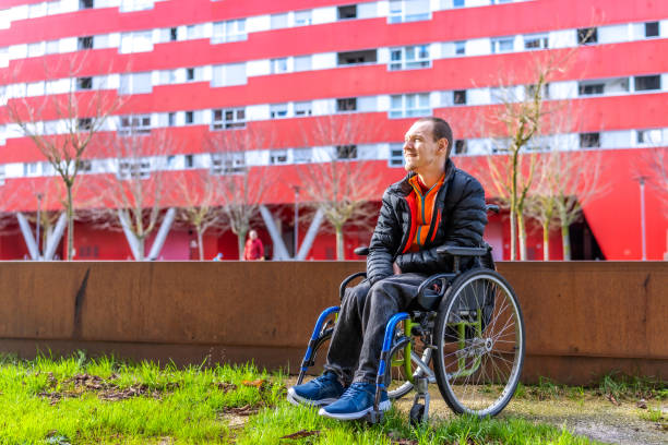 istock Young man with a disability in a wheelchair 2199067431