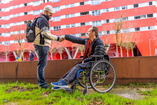 istock Mature man and young friend with disability spending day together 2199067484