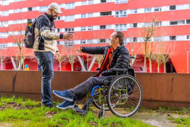 istock Mature man and young friend with disability spending day together 2199067491