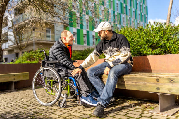 istock Mature man and young friend with disability spending day together 2199067561