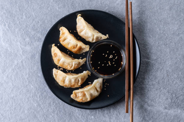 istock Fried dumplings gyoza on gray background 2199069957