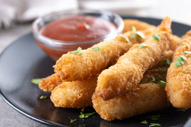 istock Breaded Torpedo shrimps on wooden table 2199070324