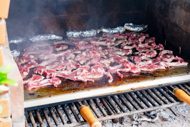 istock Lamb chops cooking on a smoking grill. Outdoor barbecue. 2199077210