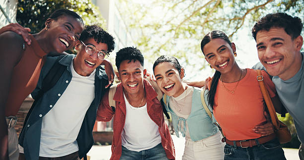 istock Students, group and happy in low angle, hug and circle with diversity, support and back to school for education. People, friends and smile with embrace, learning or scholarship portrait at university 2199077266