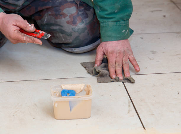 istock A man is kneeling on the floor and wiping his hands with a towel 2199078098