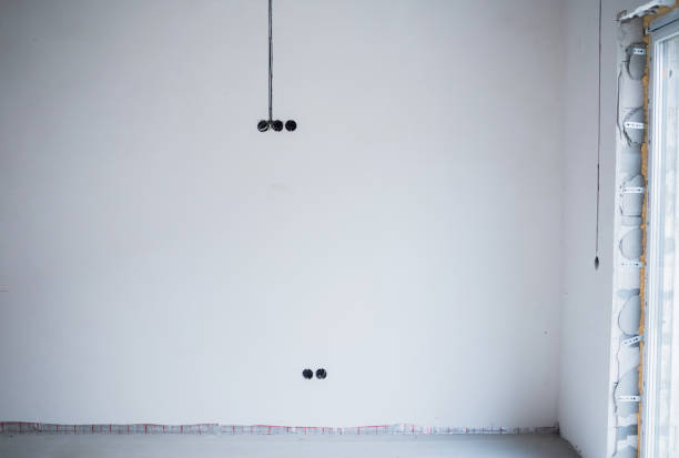 Unfinished interior space showing blank walls and electrical preparation details.