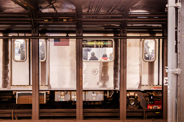 Subway train stopped at the opposite platform at an old underground subway station in New York.  The photograph is taken at the Grand Central subway station on Manhattan, New York
