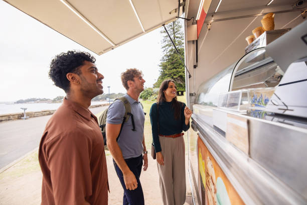istock Group of Friends Ordering Ice Cream Outdoors on a Bright Day 2199083112