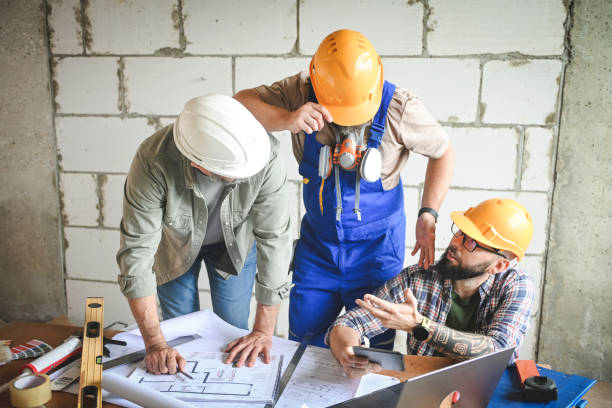 istock a team of builders, construction team is doing repairs in a new house 2199083399