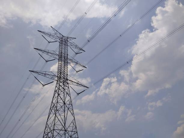 istock High voltage electric tower with clear sky and clouds background 2199088604