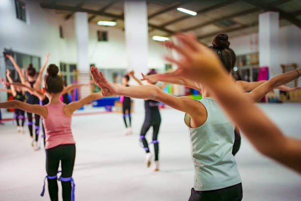 istock Young Gymnasts Practicing Ballet Poses in a Gymnastics Training Center 2199091686