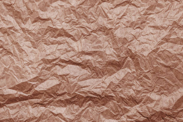 istock Elegant mocha mousse background on crumpled kraft paper texture. Mocha mousse grunge texture background. 2199092903