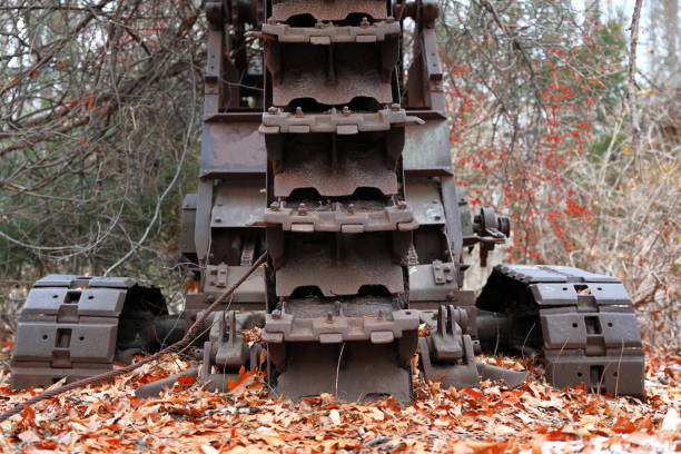 Abandoned Antique Rusted Trencher Overgrown With Brush