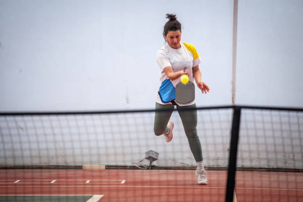 istock female pickleball player is shooting dink ball is still on racket horizontal pickleball still 2199095008