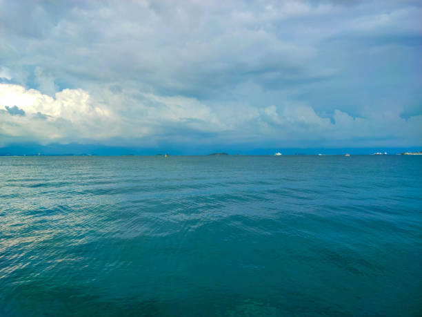 The beautiful white clouds sky and blue turquoise peaceful sea.