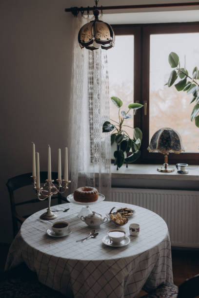 istock a beautifully set vintage-style table, adorned with elegant dishes, delicate tea cups, and a variety of delicious desserts 2199100569