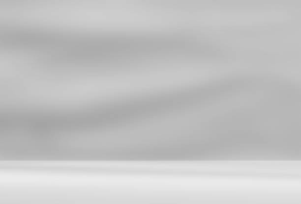istock Empty gray room studio with shadow on wall and floor for product presentation. 2199101070