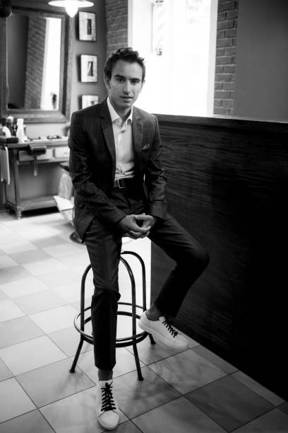 istock Young guy in grey checkered suit in barbershop 2199103250