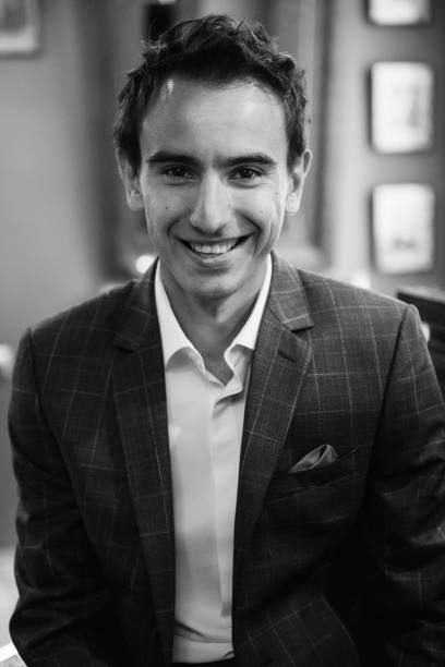 istock Young guy in grey checkered suit in barbershop 2199103657